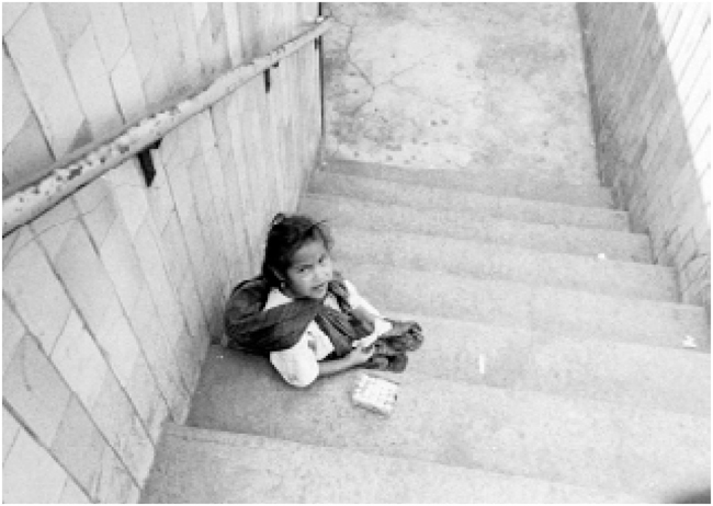 Hermanos Mayo. Young girl selling chewing gum at subway entrance, Mexico City, c. 1960. Fondo Mayo, Imágenes de la Ciudad, Archivo General de la Nación