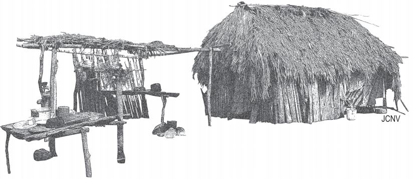 Una garita jiiwaya’ utilizada como cocina al lado de una casa tradicional
jaataka’. Elementos arquitectónicos: a) kajbri’: poste; b) juubra: vigas.

