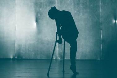 • Persona a contraluz, de pie en escenario con muletas, Reino unido, 2017 | Tomada por: Artjobs