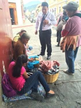 Customers buying meals from a street food vendor under the portal on the Central Plaza