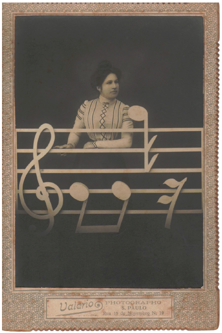 Retrato de Mulher (s.d.), Valério Vieira. A música como motivo cenográfico adotado no estúdio fotográfico.