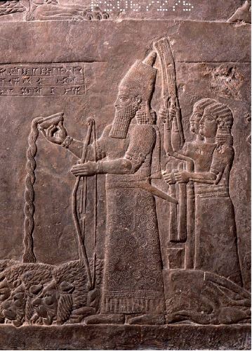 “Gypsum wall relief panel. The king himself is pouring a libation, which the caption tells us is wine, over the bodies of four lions. Behind him stand attendants with fans and towels, his bodyguards and grooms with the royal horses. Production date: 645-640 BCE”.