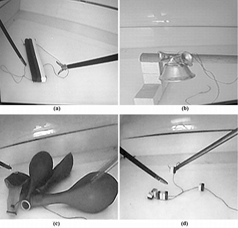 Suturing tests: (a) S1-Play-Doh: to suture three Play-Doh bars using a single thread, (b) S2-Bells: to tie up three toy bells to a stick using the rings attached to them, (c) S3-Ballons: to tie up four elastic balloons from their marked end, and (d) S4-Collar: to make a collar using six plastic rings and tie them up with a thread.