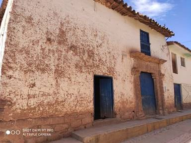 Fachada de vivienda tradicional con portada de piedra labrada.