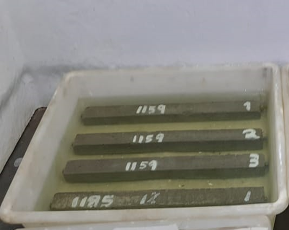 Mortar specimens immersed in a NaOH solution for expansion tests.