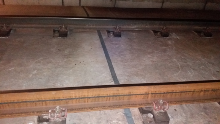 Optical fiber protected under train tracks.