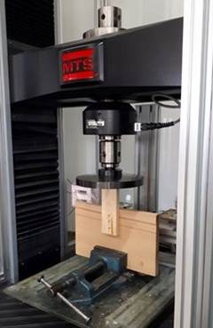 Test set-up for evaluating lateral shear load resistance of staple-connected wood joints.