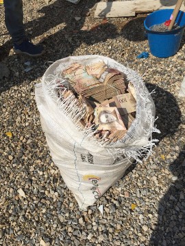 A bag of bolivars, paid by the weight.