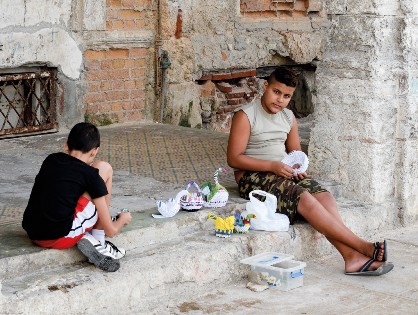 Children in Havana, Cuba creating and selling 3D origami sculptures out of paper