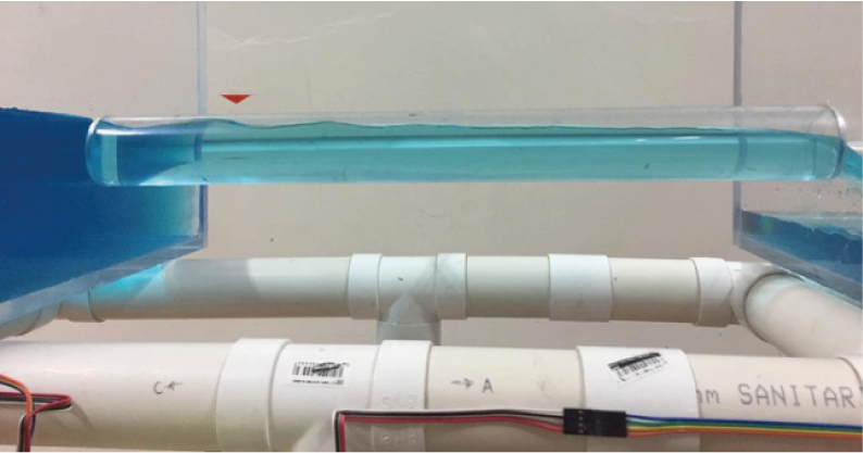 Undular hydraulic jump at the inlet caused by flow depression under weir-type operating.