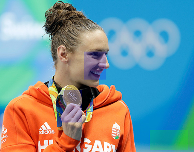 Athlete holding medal, extracted from report B2.