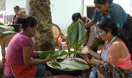 Preparing ceremonial tamales with xeel leaves