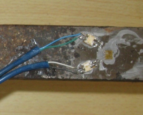 Strain gages stuck on the underside of the beam.