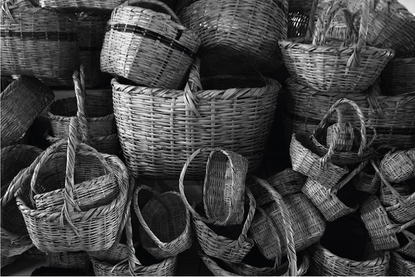 Natural wicker fibers are transformed into handcrafted utilitarian baskets. Latacunga, Ecuador.